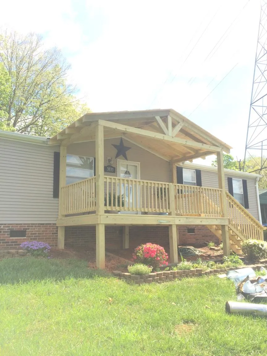 New gabled porch roof and deck railing added to a ranch home in Portsmouth